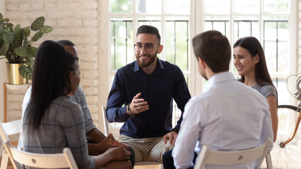 group therapy session discussing the stages of addiction