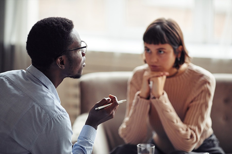 a woman looking at therapist in counseling