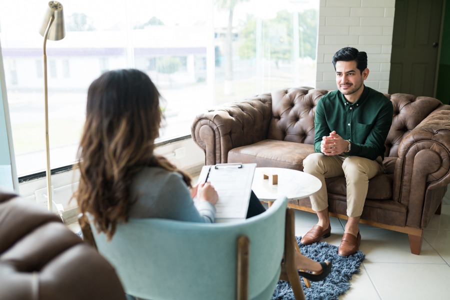 a man smiling in individual therapy