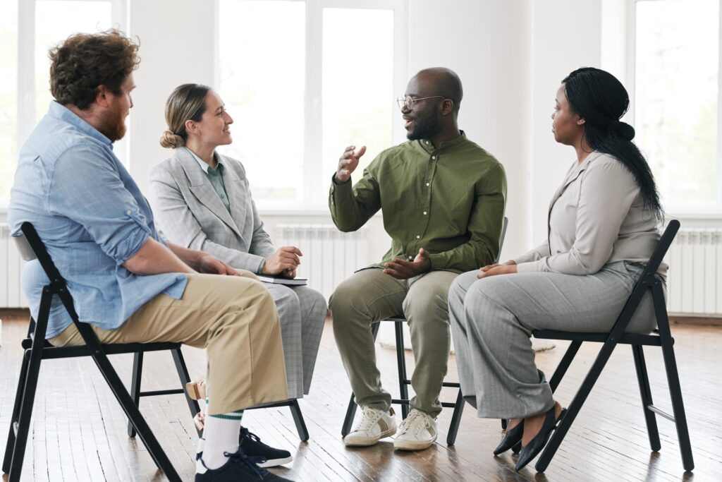 a man speaking in group therapy