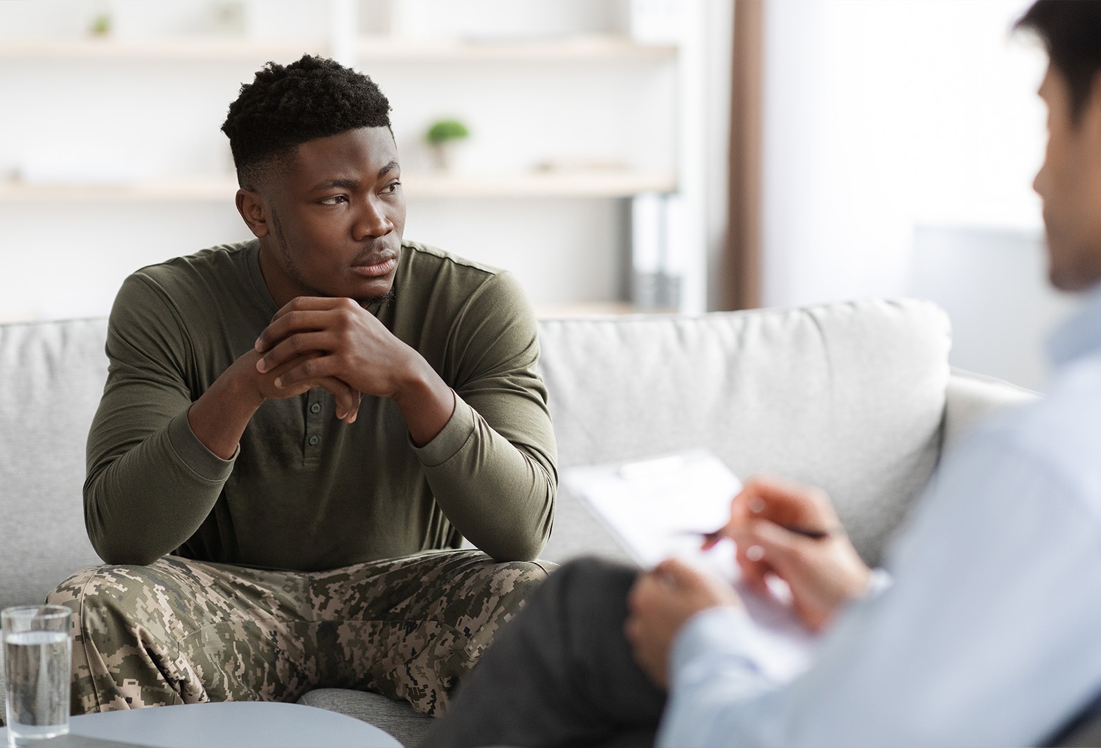 therapist guiding a veteran at a PTSD rehab center
